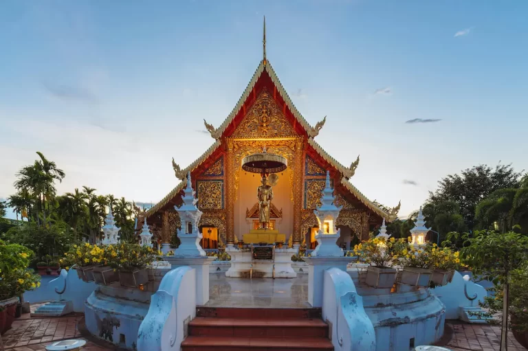 Wat Phra Singh Temple illuminated at twilight in Chiang Mai – healing through Buddhism in Thailand.